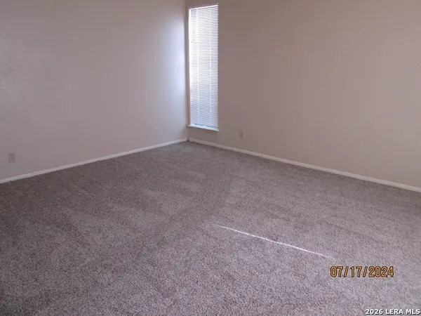 an empty room with a empty space and a ceiling fan