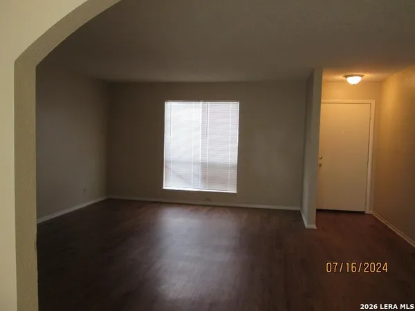 a view of an empty room and wooden floor