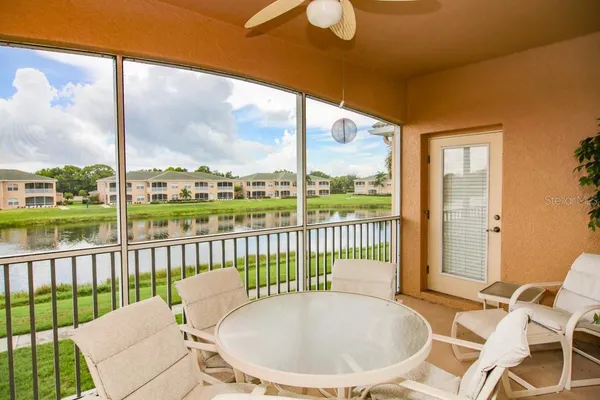 a view of a balcony with chair and wooden floor
