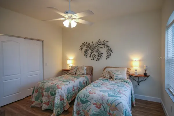 a bedroom with two beds and a chandelier