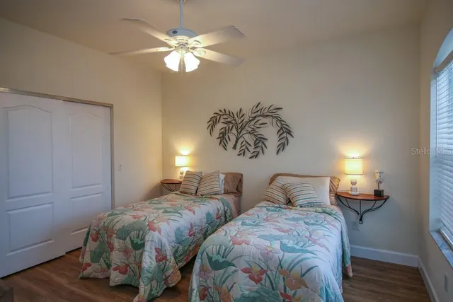 a bedroom with two beds and a chandelier