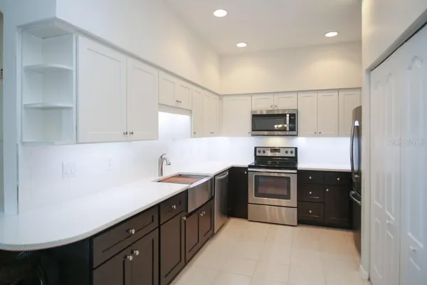 a kitchen with a sink and stainless steel appliances