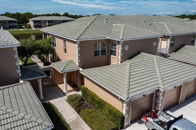 an aerial view of a house with swimming pool and furniture