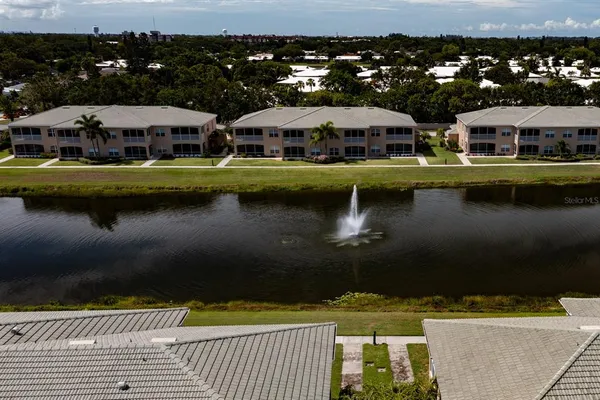 a view of swimming pool with outdoor seating and lake view
