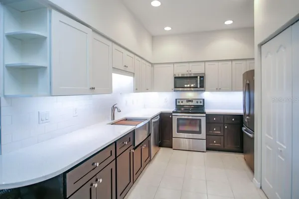 a kitchen with stainless steel appliances granite countertop a stove and a refrigerator