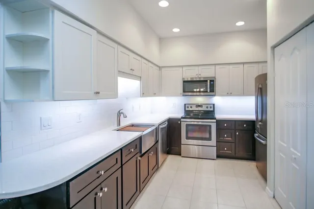 a kitchen with stainless steel appliances granite countertop a stove and a refrigerator
