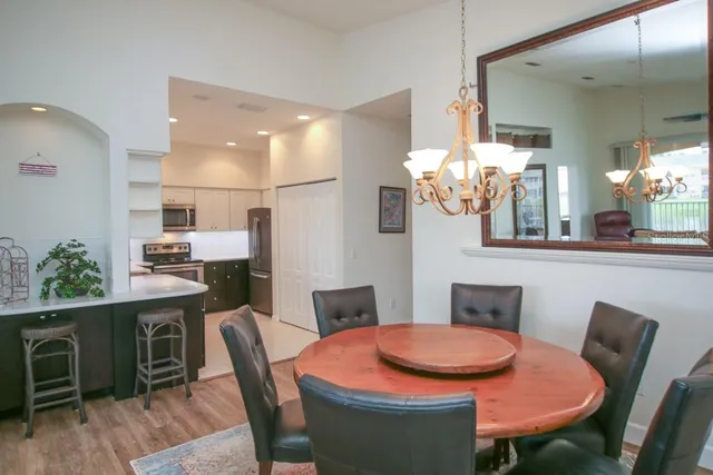 a dining room with furniture and wooden floor