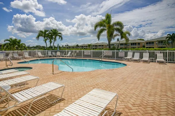 a view of a swimming pool with a lounge chair
