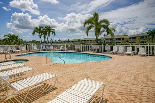 a view of a swimming pool with a lounge chair