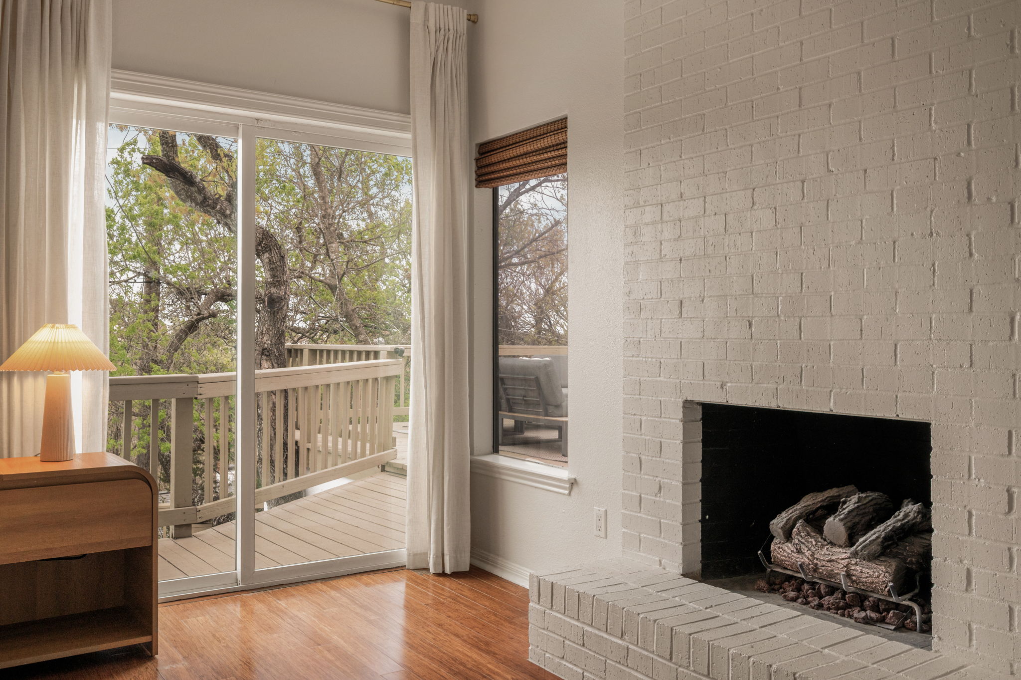 6501 Sumac Drive Austin, TX 78731 - Photo 15 of 40 Living area with light wood-style floors and a fireplace