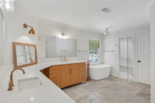 a spacious bathroom with a bathtub sink and mirror