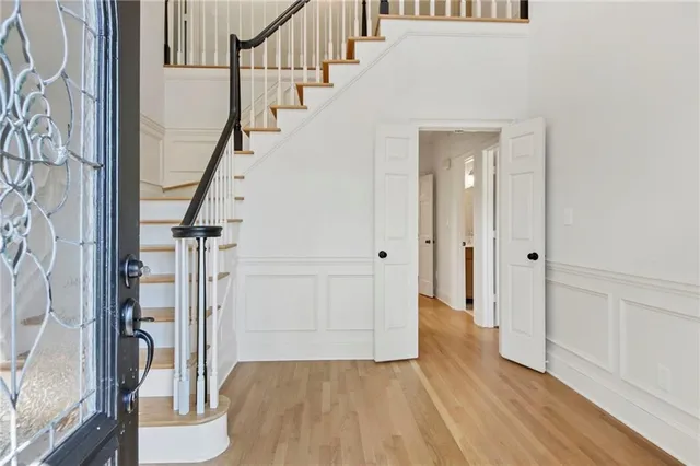 a view of an entryway with wooden floor and door