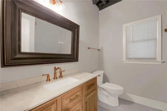 a bathroom with a toilet sink and mirror