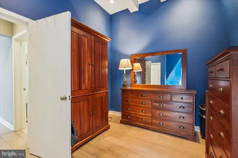 a view of walk in closet with clothes