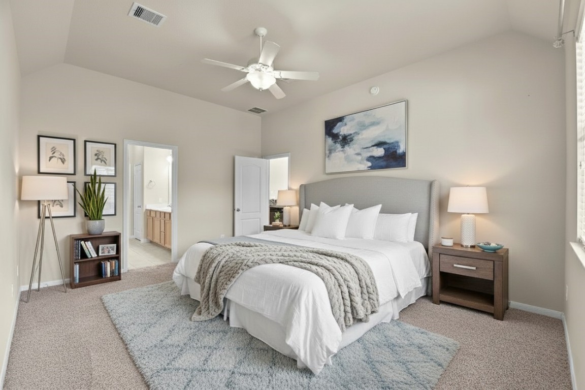 39 Butternut Grove Place Tomball, TX 77375 - Photo 12 of 29 a bedroom with a bed lamps and chairs