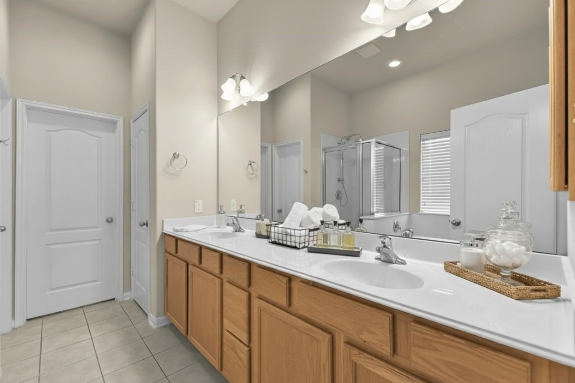 39 Butternut Grove Place Tomball, TX 77375 - Photo 14 of 29 a bathroom with a sink double vanity and a mirror