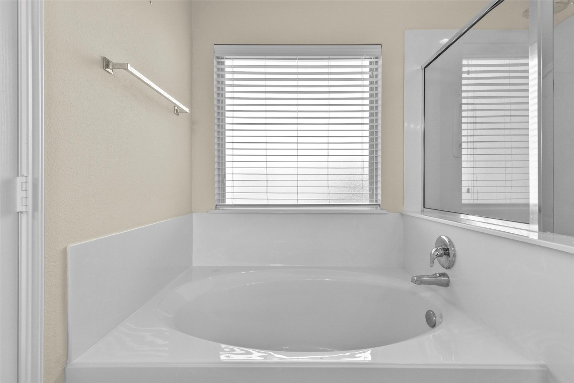 39 Butternut Grove Place Tomball, TX 77375 - Photo 16 of 29 a white bath tub sitting in a bathroom next to a window