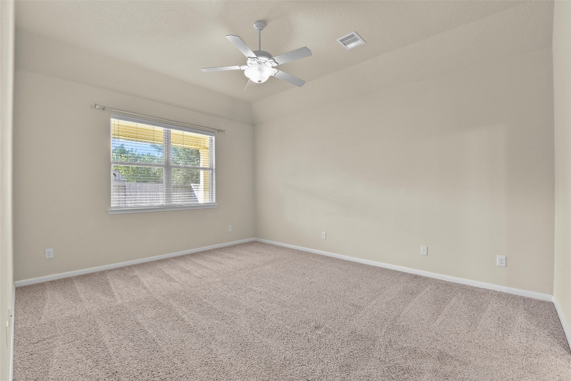 39 Butternut Grove Place Tomball, TX 77375 - Photo 19 of 29 an empty room with windows and fan