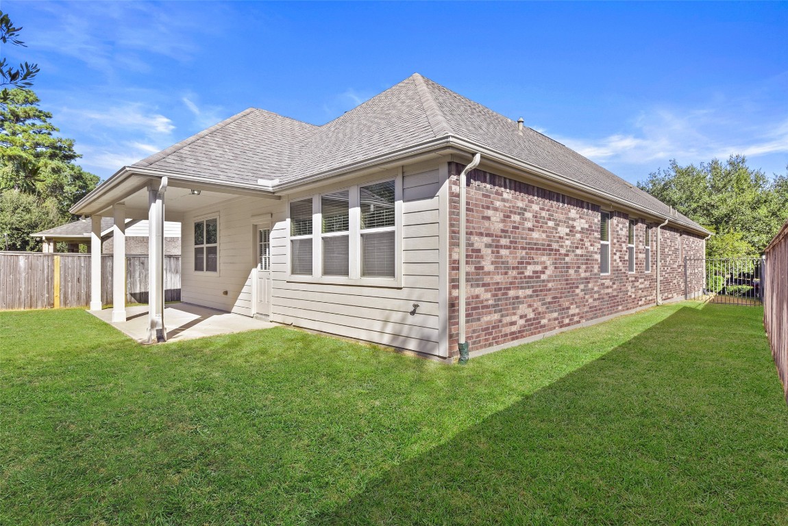 39 Butternut Grove Place Tomball, TX 77375 - Photo 29 of 29 a view of a house with a yard and sitting area