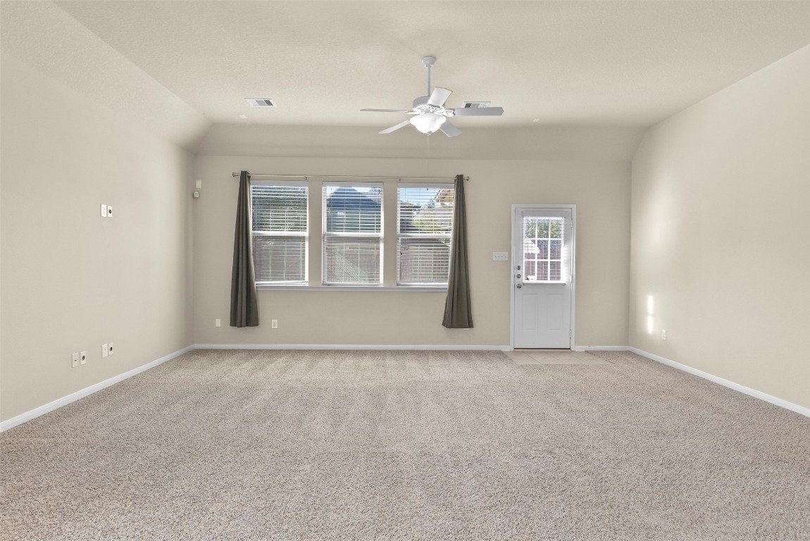 39 Butternut Grove Place Tomball, TX 77375 - Photo 4 of 29 a view of an empty room with chandelier fan and windows