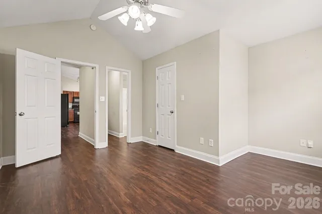 an empty room with wooden floor and closet