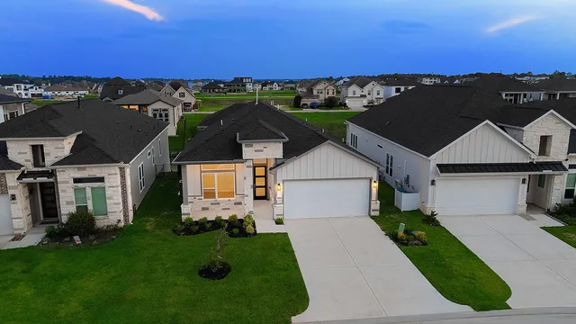 an aerial view of a house with a yard