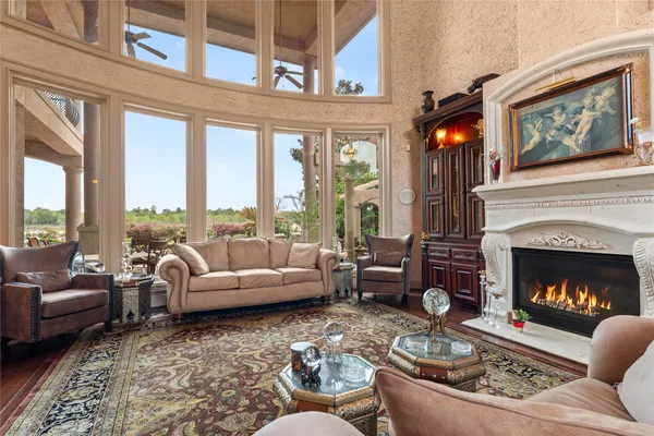 a living room with furniture large window and a fireplace