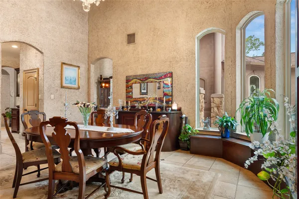 a view of a dining room with furniture and a potted plant