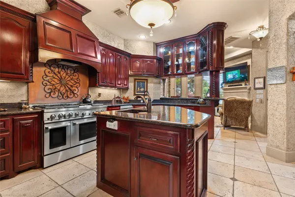 a kitchen with stainless steel appliances granite countertop a stove and a sink