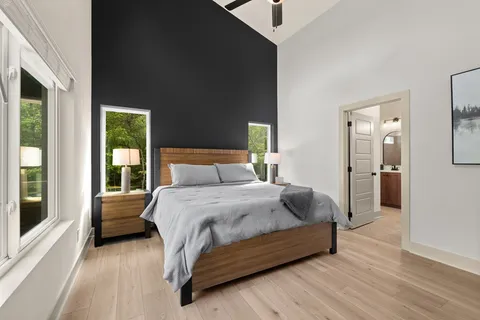 a bedroom with a bed and a large window