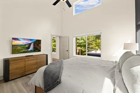 a bedroom with a bed and a flat screen tv