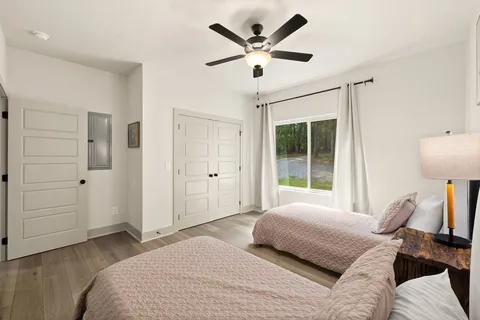 a bedroom with a large bed and a window