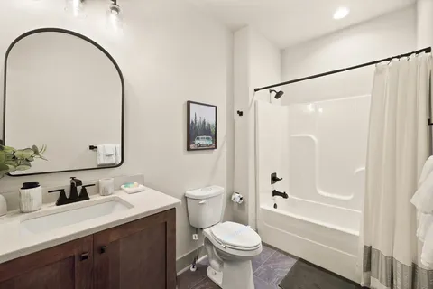 a bathroom with a sink toilet and shower