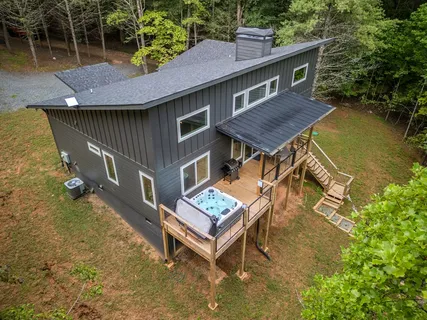 a view of a house with pool and a yard