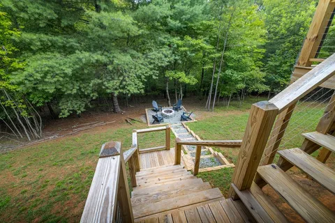 a view of a deck with chairs next to a yard