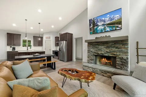 a living room with furniture a flat screen tv and a fireplace