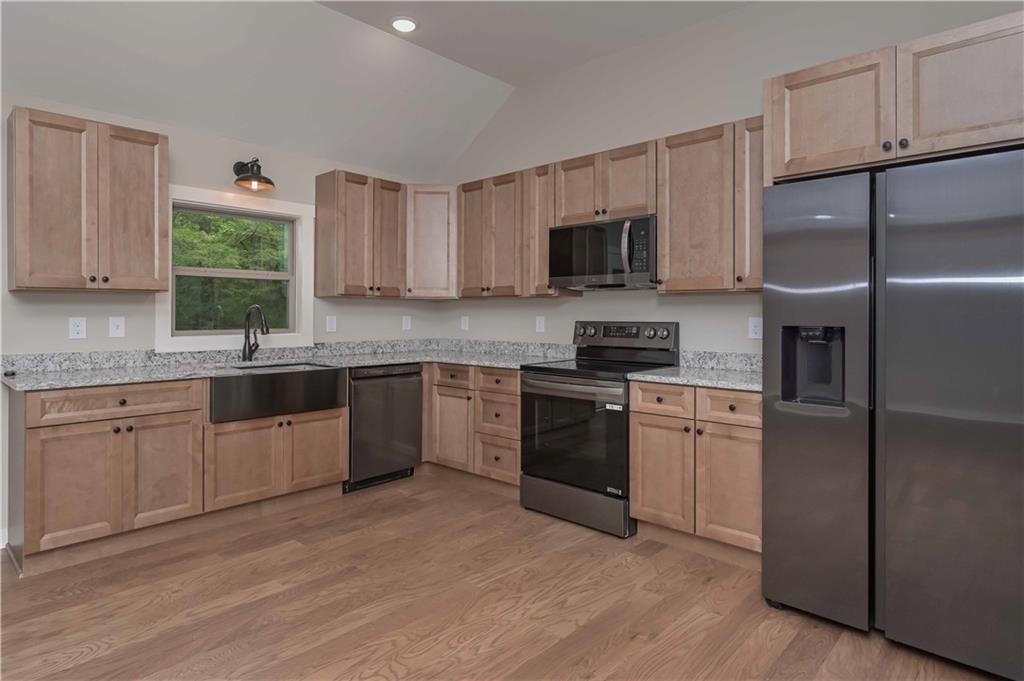 15 Weaver Street Buchanan, GA 30113 - Photo 12 of 22 a kitchen with stainless steel appliances granite countertop a refrigerator sink and stove