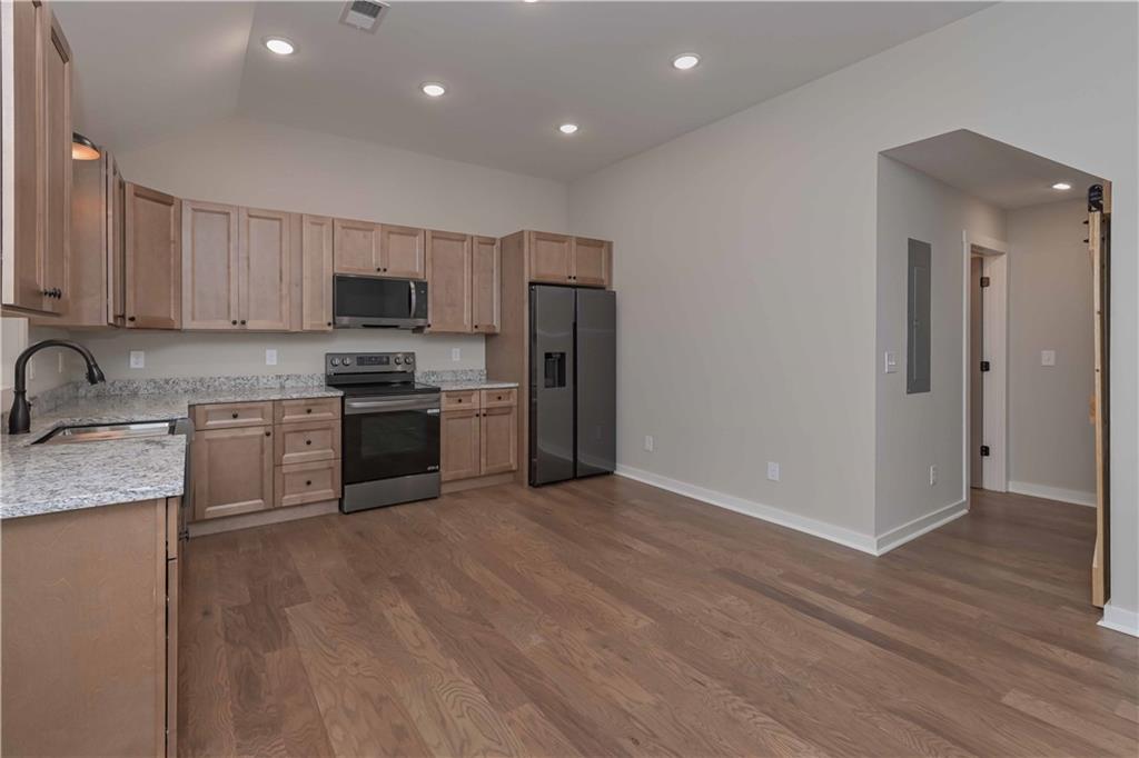 15 Weaver Street Buchanan, GA 30113 - Photo 13 of 22 a kitchen with stainless steel appliances granite countertop a stove a sink and a refrigerator