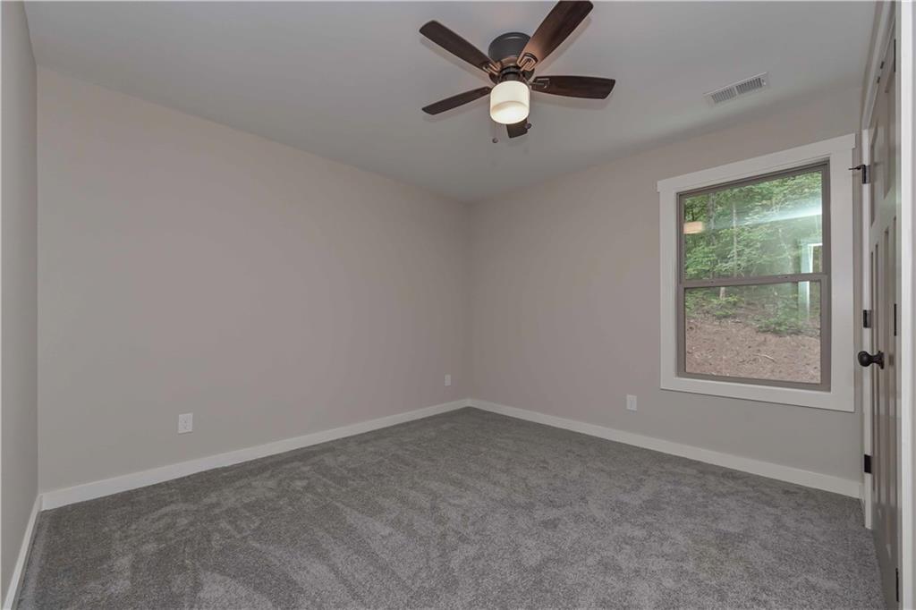 15 Weaver Street Buchanan, GA 30113 - Photo 16 of 22 an empty room with a window and a fan