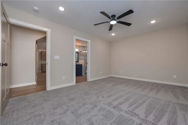 an empty room with closet and ceiling fan