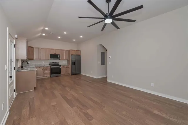 a view of kitchen with stainless steel appliances refrigerator stove microwave and cabinets