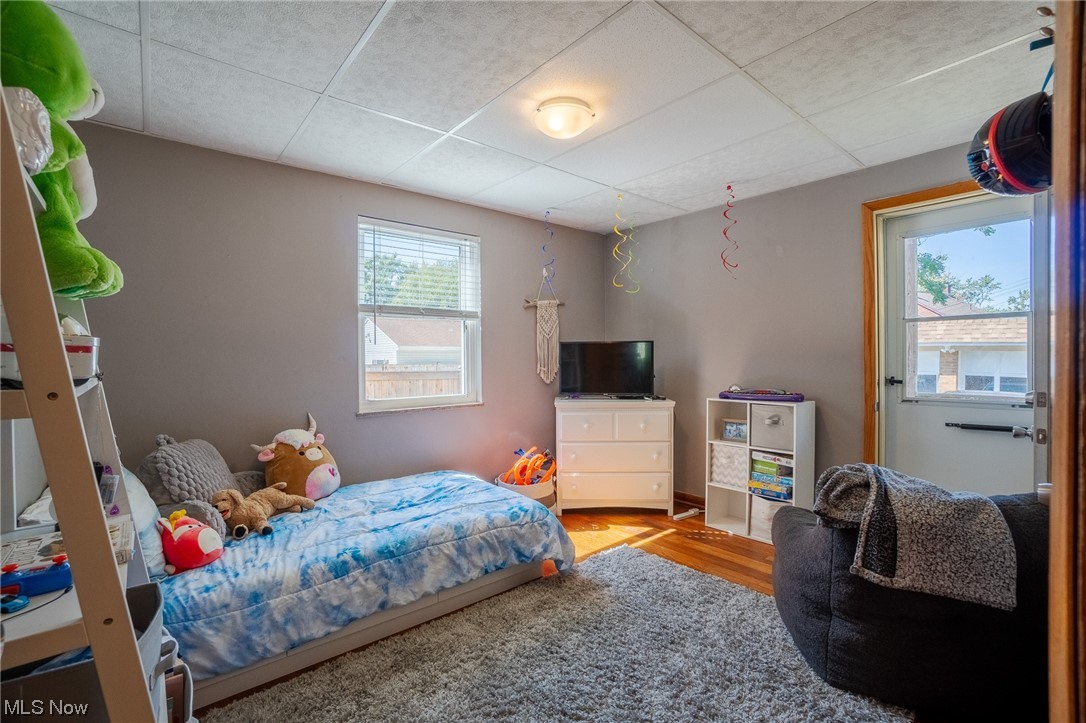 15022 Triskett Road Cleveland, OH 44111 - Photo 13 of 35 Hardwood floored bedroom with a drop ceiling