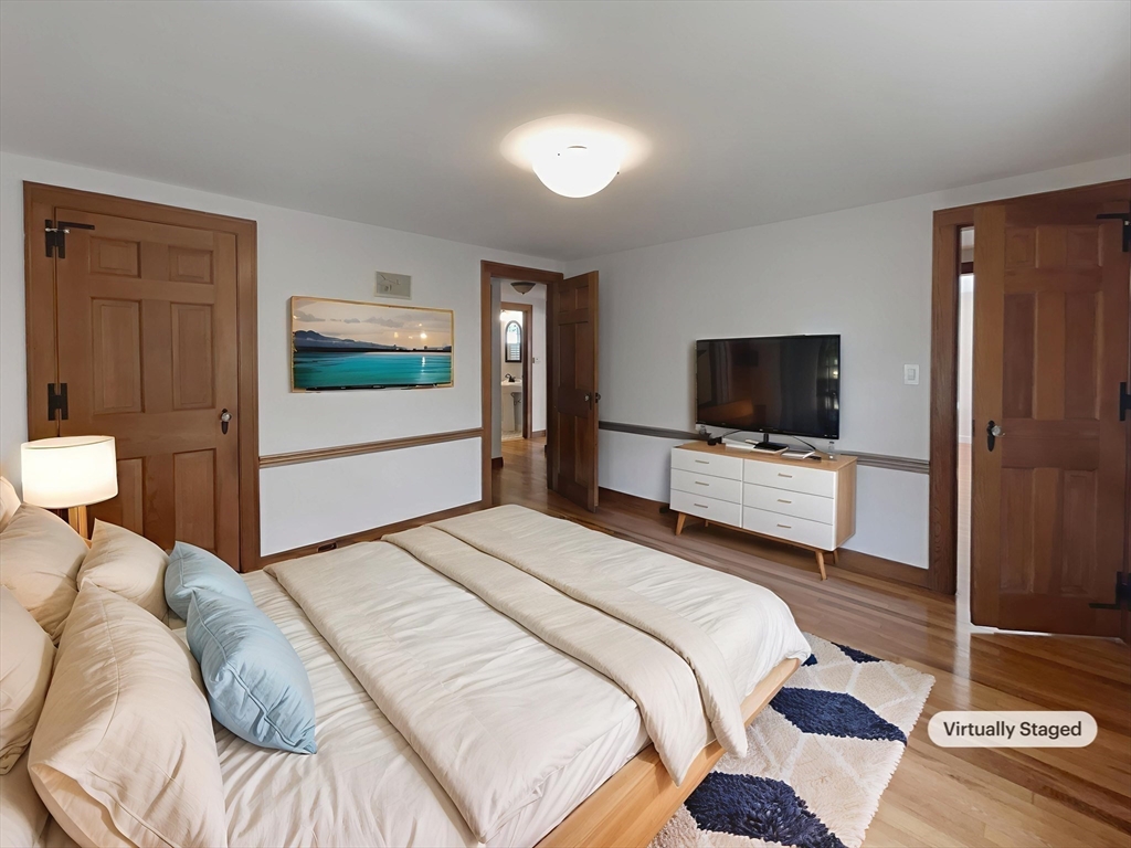 337 Edgell Road Framingham, MA 01701 - Photo 16 of 36 a bedroom with a bed and a flat screen tv