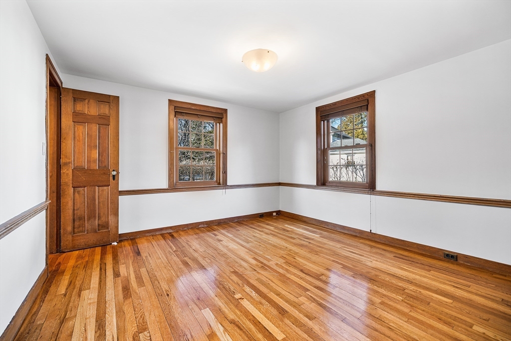 337 Edgell Road Framingham, MA 01701 - Photo 17 of 36 a view of an empty room with wooden floor and a window