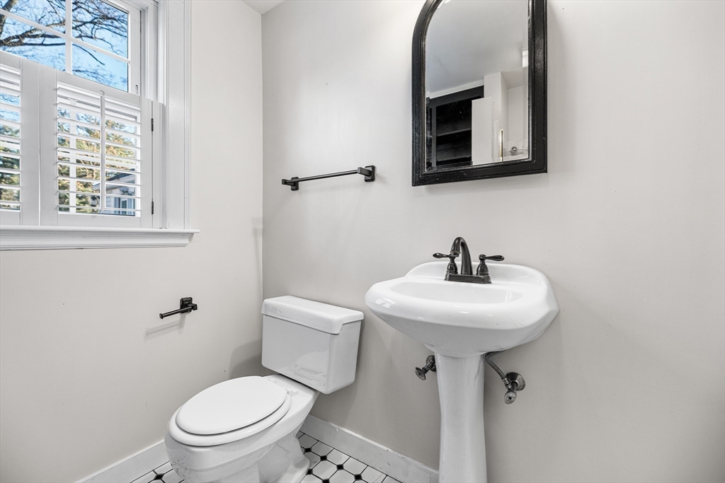 337 Edgell Road Framingham, MA 01701 - Photo 18 of 36 a bathroom with a toilet sink and mirror