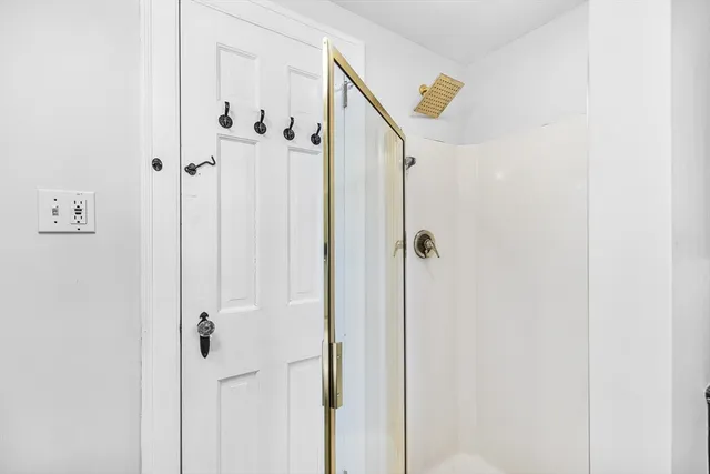 a view of empty room with wooden floor and windows