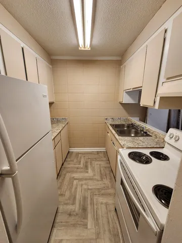 a kitchen that has a sink and a stove