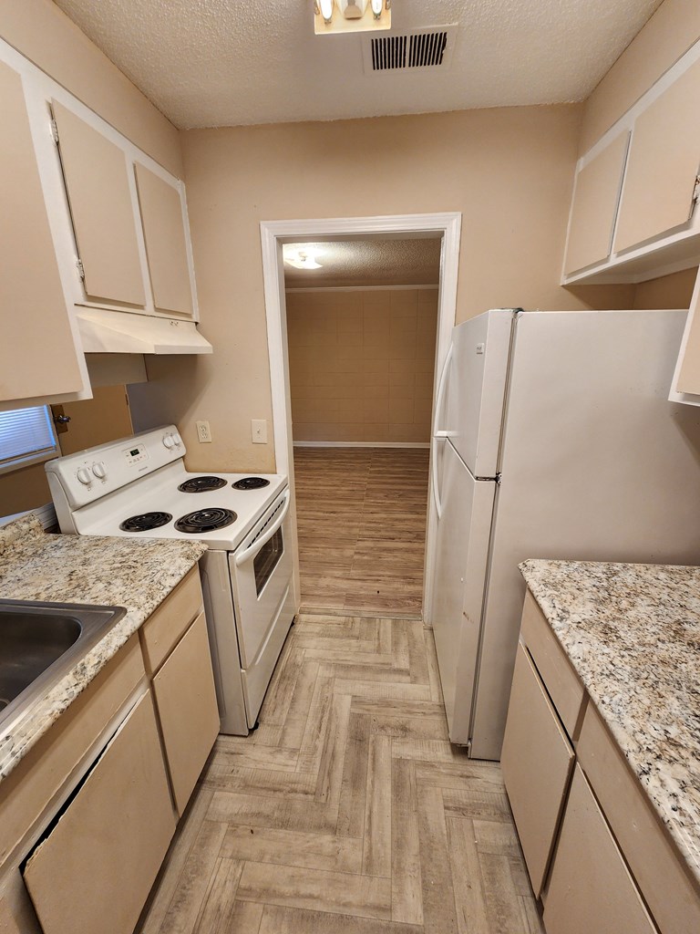 3981 Holly Avenue, Unit 8 Columbus, GA 31904 - Photo 3 of 8 a kitchen with a sink stove and refrigerator
