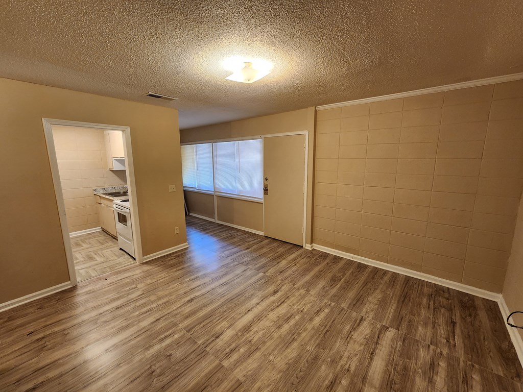 3981 Holly Avenue, Unit 8 Columbus, GA 31904 - Photo 8 of 8 wooden floor in an empty room with a window