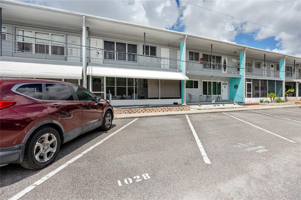 4152 55th Way North, Unit 1028 Kenneth City, FL 33709 - Photo 1 of 46 a view of a car parked in front of a building
